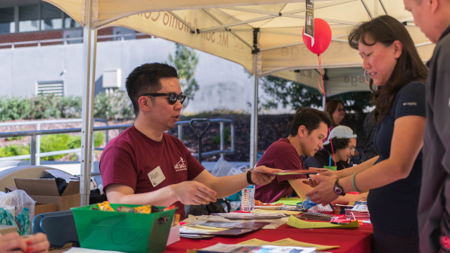 Staff member at registration table with guest