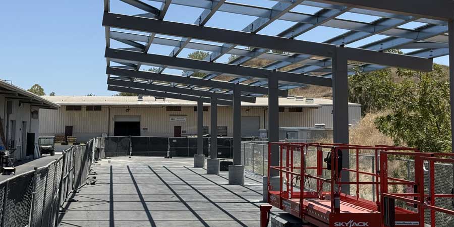 framing of solar panels next to facilities