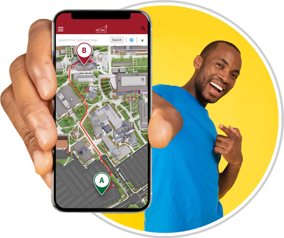 Person holding phone with walking directions displayed from Lot B to Bldg 9B.