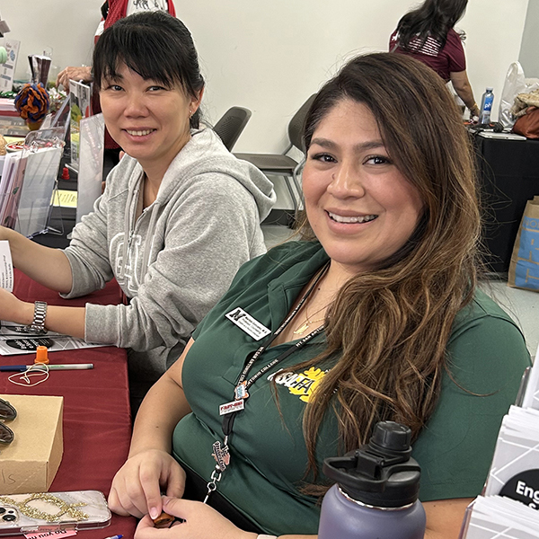 School of Continuing Education staff members get ready to greet the public at an informational booth.