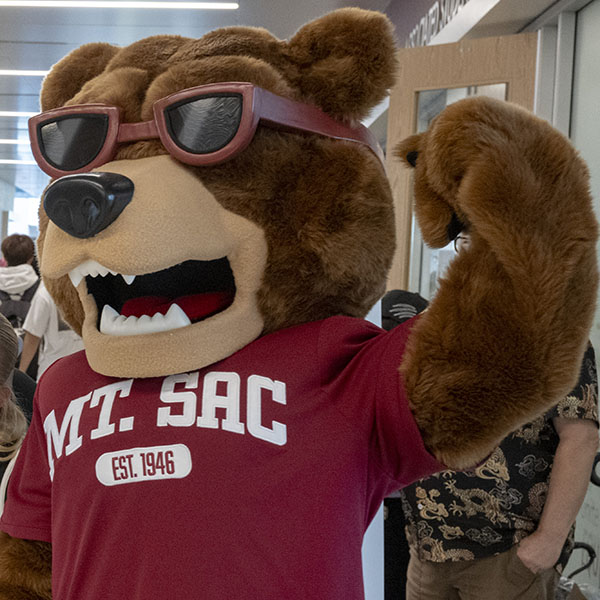 Mt. SAC's mascot Rizzly the Grizzly flexes his muscles.