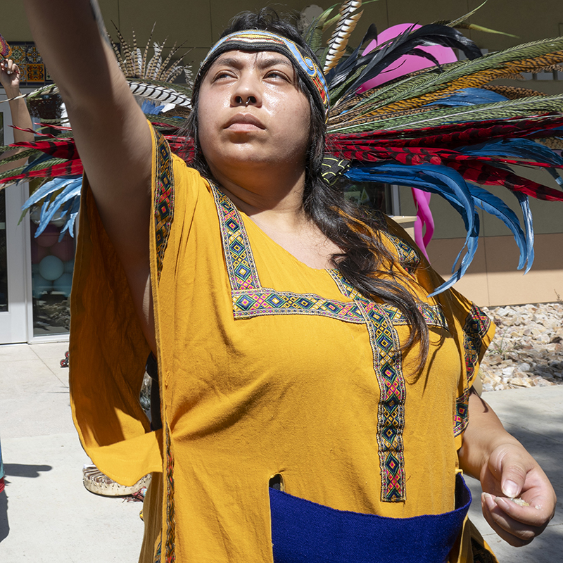 A Native American performs a dance at a grand opening ceremony.