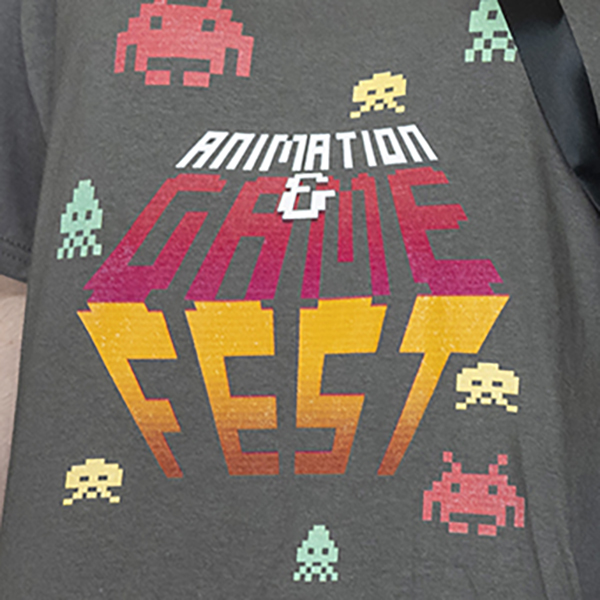 A closeup of a shirt with the Animation and Gamefest logo on it.