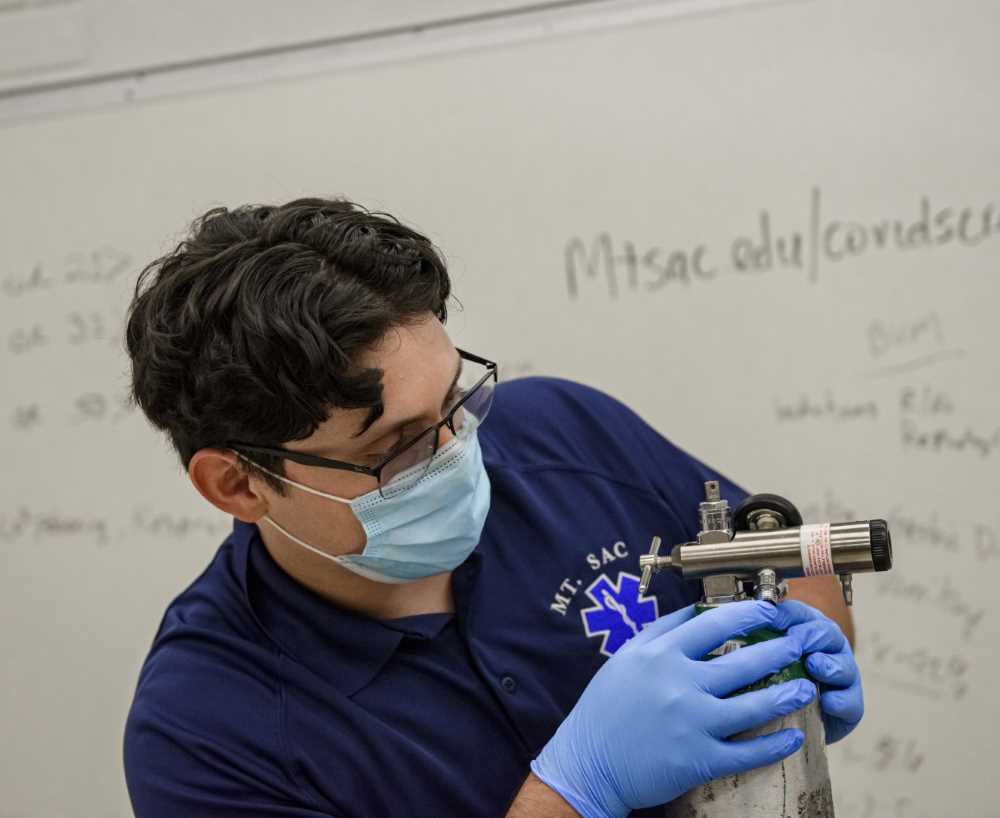 EMT student learns equipment