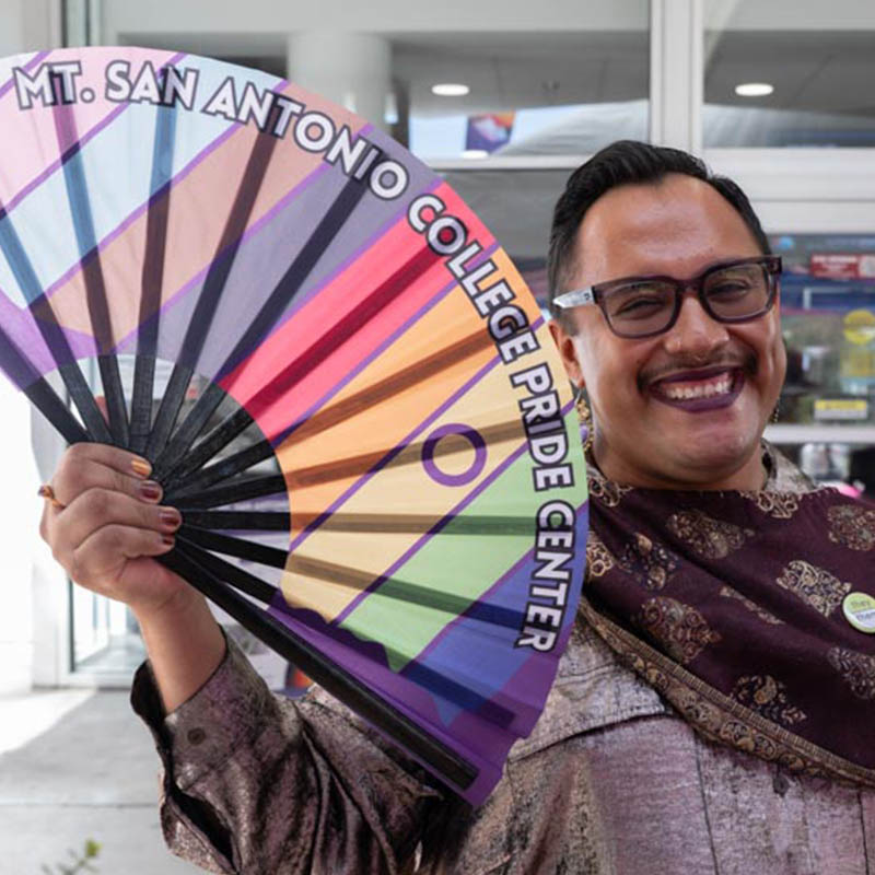 Rony Castellanos Raymundo holds Pride fan