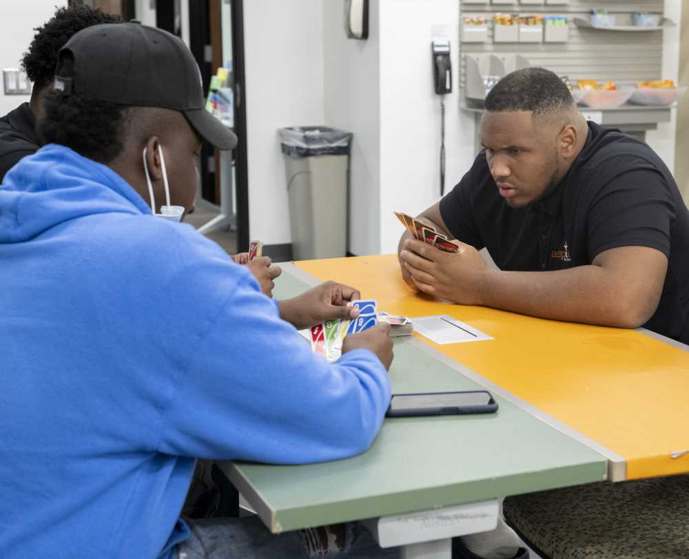 Students play card game in The Center