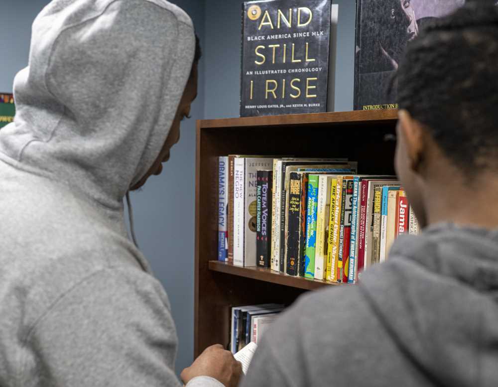 Students look at books in The Center's library