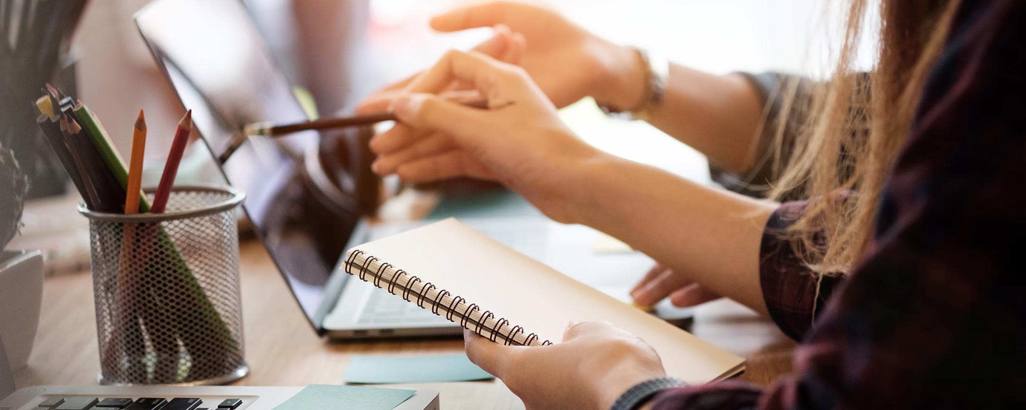 Computer, pencils, and notebooks help people do research