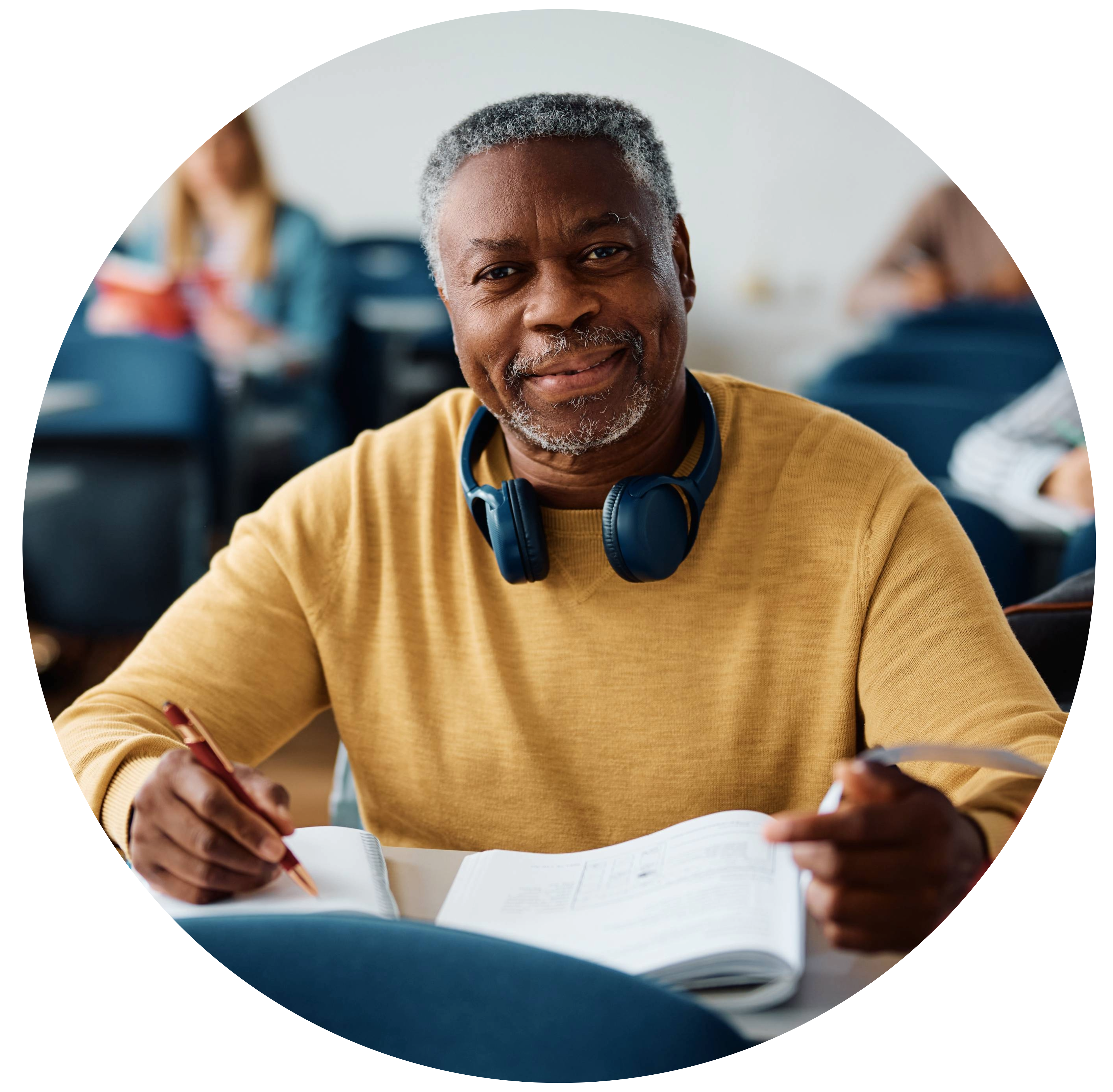 senior male student smiling at camera in a classroom