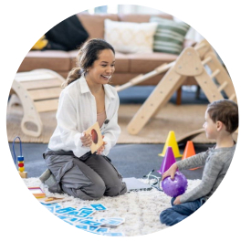 woman showing child a toy